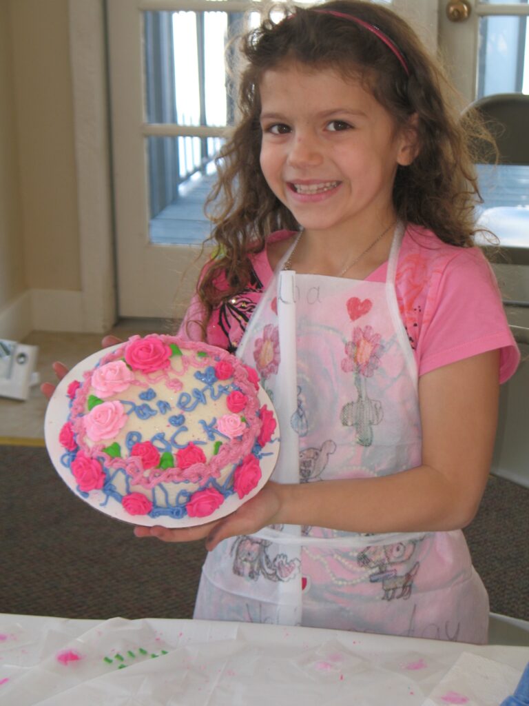 Birthday Girl showing off cake she decorated