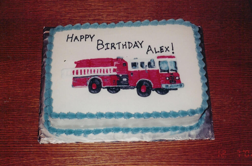 Birthday cake with a fire truck frosted on to it