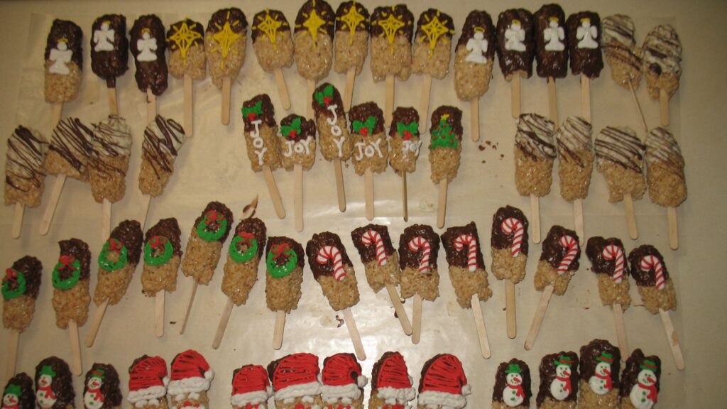 Assorted Rice Krispy pieces on sticks dipped in icing and chocolate